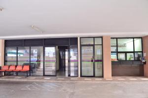 a building with glass doors and red chairs outside at jw place รามคำแหง 40 in Bangkok