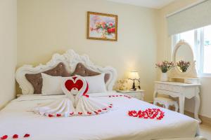a bedroom with a bed with red roses on it at Happy Star Hotel Nha Trang in Nha Trang
