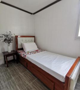 a small bed in a room with a table at Homelux Transient House in Cauayan City