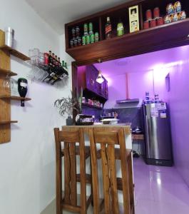 a purple kitchen with a bar and a refrigerator at Homelux Transient House in Cauayan City