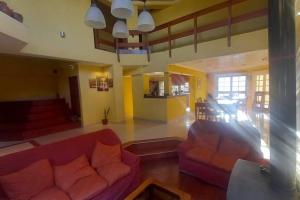 a living room with two red couches in a room at comodidad y tranquilidad in Jesús María