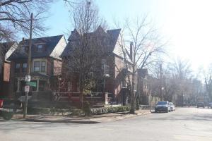 a car parked in front of houses on a street at CWE Luxury La Maison Modern in Tower Grove