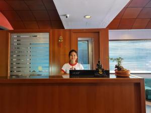 a woman sitting at a desk with a laptop at Desa Phuket in Phuket +84 photos