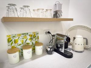 a kitchen counter with a coffee maker and a blender at Barossa Garden Homestay in Williamstown
