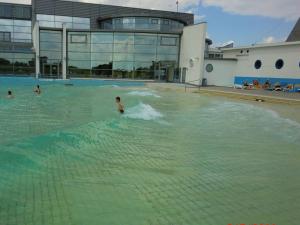 a child swimming in a swimming pool in a building at Friesengold Modern retreat in Bensersiel