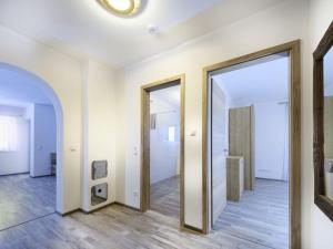 an empty hallway with two doors and a mirror at Schachen Modern retreat in Garmisch-Partenkirchen