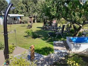 a garden with a dog sitting in the grass at "Lake view" Modern retreat in Torgelow am See