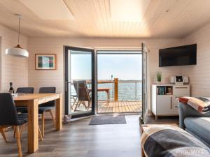 a living room with a view of the ocean at Houseboat Harmony in Stralsund