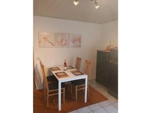 a kitchen with a table and chairs and a table and a counter at Holiday apartment Goldkäulchen in Waldrach