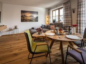 a living room with a table and a couch at Angerer - the holiday apartment 2 in Berchtesgaden