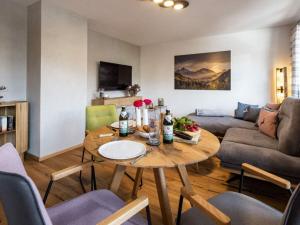 a living room with a table and a couch at Angerer - the holiday apartment 2 in Berchtesgaden