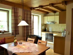 a kitchen and dining room with a table and a dining room at Nice apartment in Bavaria in Oberstaufen