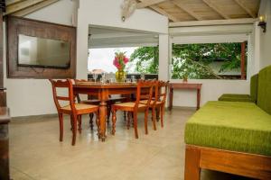 a dining room with a table and chairs and a television at Villa Ramfort, Galle Fort in Galle