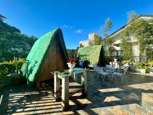 a patio with a table and a tent at A. Divine's Tagaytay Staycation in Tagaytay