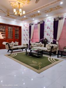 a living room with two couches and a rug at 2 bedroom Independent house Valencia town Lahore in Lahore