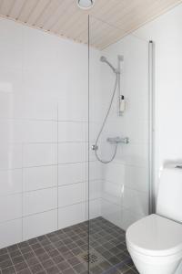 a bathroom with a toilet and a glass shower at 2BR design home 400 m from train station Tikkurila in Vantaa