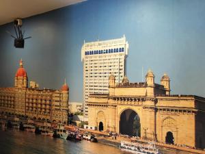 a large building next to a river with buildings at New Prakash Intl Airport in Mumbai