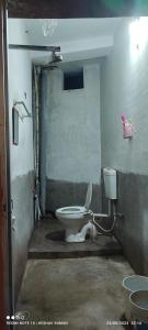 a dirty bathroom with a toilet in a room at Suman niwas in Darbhanga