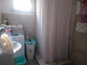a bathroom with a shower curtain and a sink at Landhaus in Bosanska Dubica