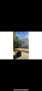 a picture of a bench in front of a house at הוילה הסודית שלי in Kefar H̱ananya