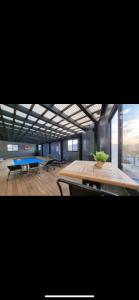 a large room with a table and a blue bench at הוילה הסודית שלי in Kefar H̱ananya