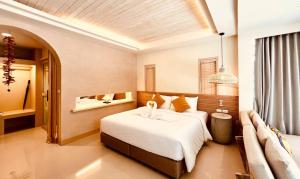A bed or beds in a room at Amity Beach Resort