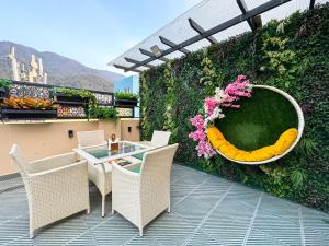 a patio with a table and chairs and a fake banana at Green View by Green Tree Hotels in Rishīkesh