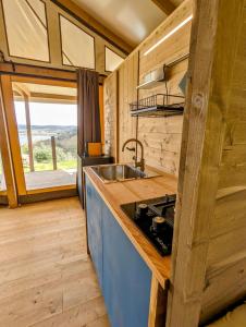 a kitchen with a sink and a counter top at Glamping Stregaia in Massa Marittima