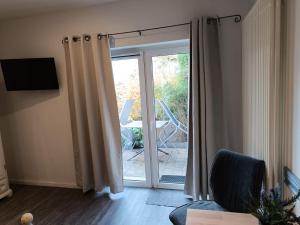 リュッベンにあるKastanienhof Lübbenのガラスの引き戸のあるリビングルーム