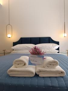 a bed with towels and a box on it at MUSES LUXURY SUITES in Corfu