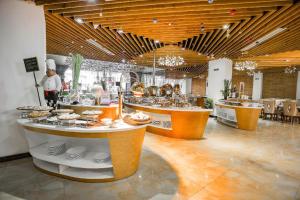 a restaurant with a buffet line with food on display at TND Hotel in Nha Trang