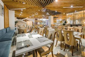 a restaurant with wooden ceilings and tables and chairs at TND Hotel in Nha Trang +46 photos
