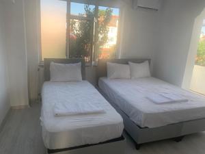 two beds sitting next to each other in a room at ULASOTEL22 in Edirne