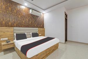 a bedroom with a large bed in a room at Collection O The Crestelia in Lucknow