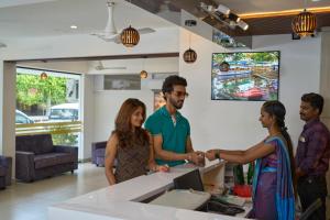 a group of people shaking hands in a room at Venice Iva Residency in Alleppey