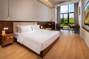 Posteľ alebo postele v izbe v ubytovaní Wuyu Hotel, Smart Park & Happy Valley Jinshansi Metro