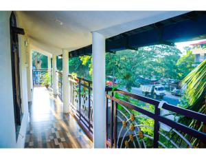 a balcony of a house with a view of a street at Manorama Lodge, Kohora in Hatikhuli
