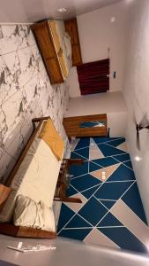 a room with a floor with blue and white tiles at Lucky star hotel in Bhāgamandala