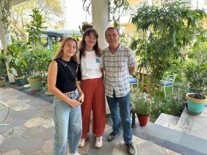 three people posing for a picture in a garden at Dá Bungalow - A Vacation Abode in Agra