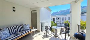 a living room with a couch on a balcony at 700m From Franschhoek Center in Franschhoek