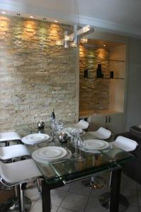 a dining room with a table and white chairs at Villa No2 - Sun Tan Palmar in Belle Mare