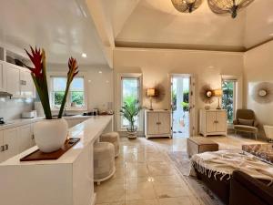 a kitchen and living room with a vase of flowers at Moon Villas Umalas in Canggu