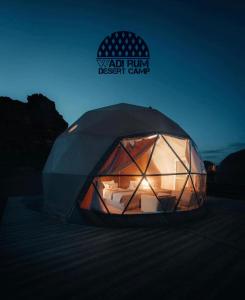 a tent with a light inside of it at Wadi Rum desert camp in Wadi Rum