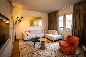 Luxe Appartement nabij centrum في زفوله: غرفة معيشة مع أريكة وكرسي