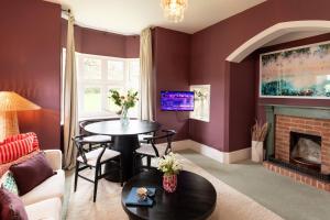 a living room with red walls and a fireplace at Estate Lodge Sleeps 5 on The Jurassic Coast Devon in Sidbury