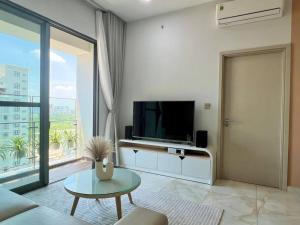 a living room with a television and a large window at The Ascentia - Scandinavian apartment - Near SECC, Mall in Ho Chi Minh City