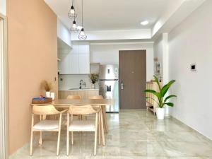 a kitchen with a table and chairs and a refrigerator at The Ascentia - Scandinavian apartment - Near SECC, Mall in Ho Chi Minh City