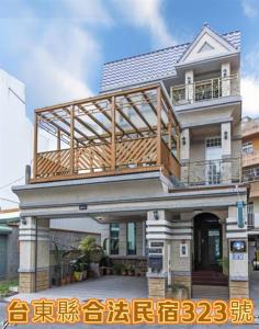 a house with a deck on top of it at Taitung Leisure B&B in Taitung City