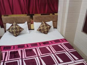 Una cama con dos almohadas encima. en Arora classic guest house en Amritsar