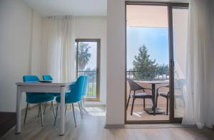 a dining room with a table and chairs and a balcony at SEASIDE APART OTEL- 400 meter to sea! in Side